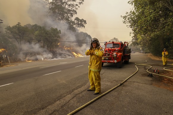 epa08704842 A member of the Eagle Field Fire Department uses a restored 1942 US Army fire truck to fight the Glass Fire burning near the town of St. Helena in Napa County, California, USA, 28 Septembe ...