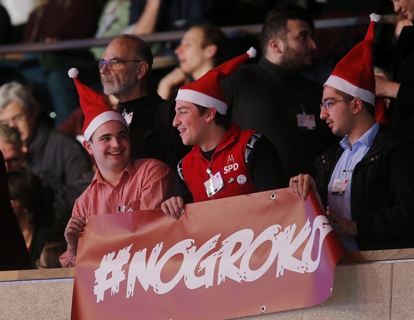 Young men demonstrate against a coalition between CDU and SPD during a party meeting of the Social Democrats, SPD, who are discussing the possible coalition talks with Chancellor Angela Merkel&#039;s  ...