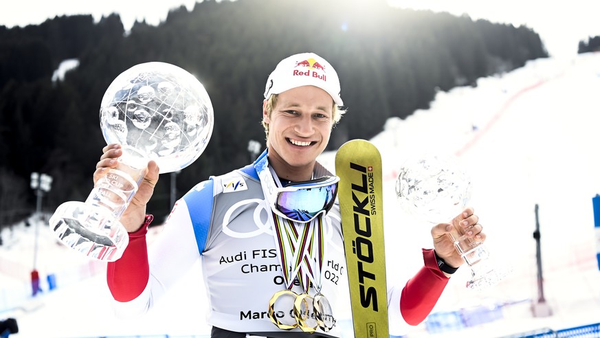 Marco Odermatt of Switzerland poses with the men&#039;s overall crystal globe trophy and the men&#039;s Giant-Slalom overall leader crystal globe trophy after the podium ceremony at the FIS Alpine Ski ...