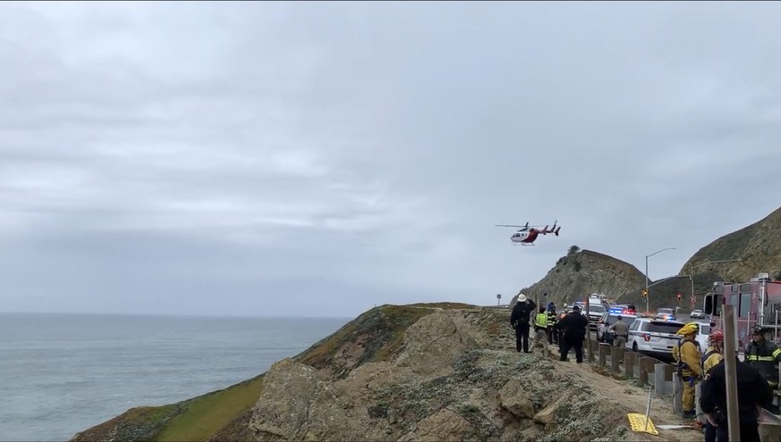 FILE - This frame of video provided by Cal Fire San Mateo, Santa Cruz Unit, emergency responders respond to the scene after a Tesla plunged off a cliff along Pacific Coast Highway, Monday, Jan. 2…