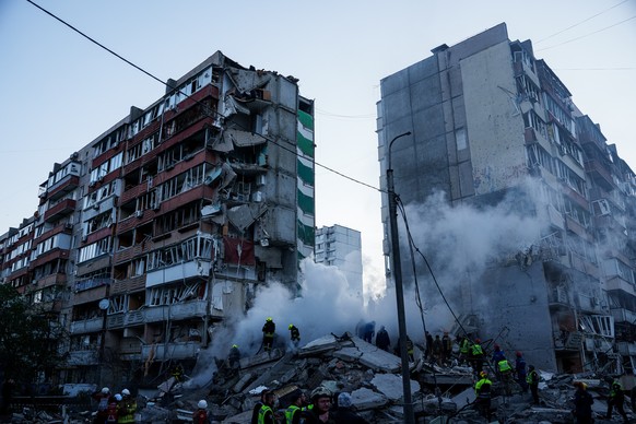 Rescue workers clear the rubble of a house heavily damaged after a Russian strike on a residential neighborhood in Kyiv, Ukraine, on Thursday, May 14, 2026. (AP Photo/Evgeniy Maloletka)
APTOPIX Russia ...