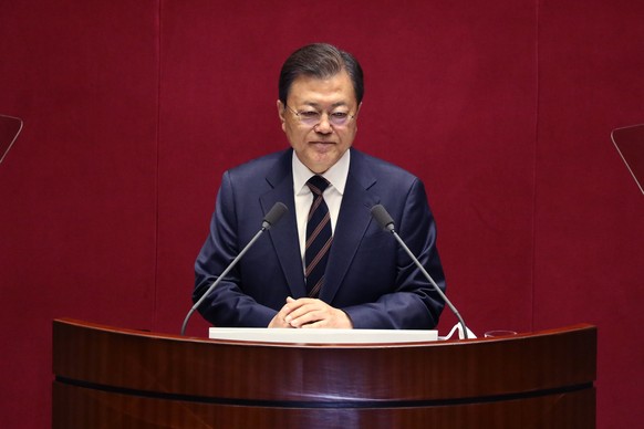 epa09544758 South Korean President Moon Jae-in speaks at the National Assembly in Seoul, South Korea, 25 October 2021. President Moon spoke for parliamentary cooperation in passing an expansionary gov ...