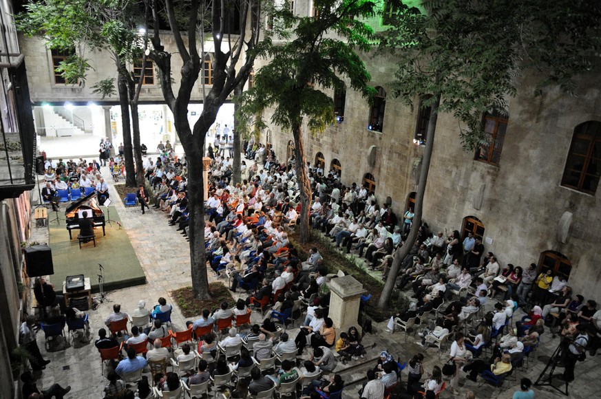 People attend a music concert in al-Sheebani school's courtyard, in the Old City of Aleppo, Syria June 6, 2009. REUTERS/Omar Sanadiki SEARCH "ALEPPO HERITAGE" FOR THIS STORY. SEARCH &qu ...