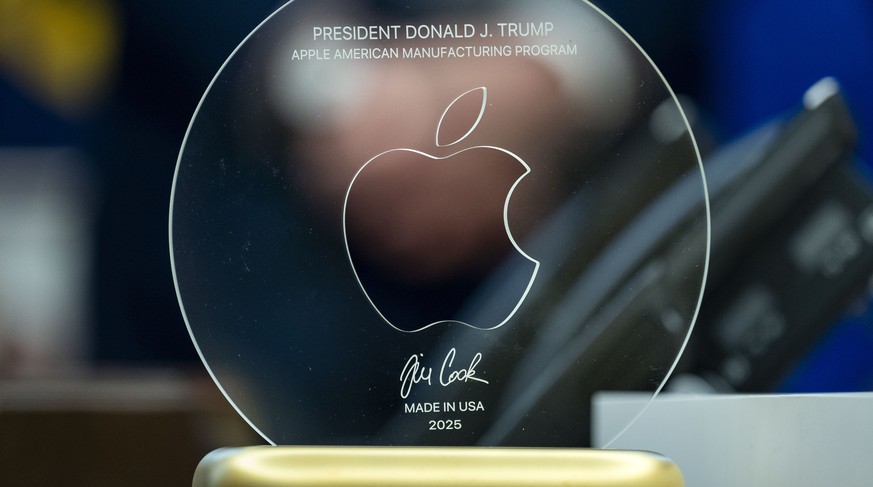 epa12287414 A plaque commemorating President Donald Trump?s and Apple CEO Tim Cook's announcement an additional $100 billion Apple investment in the US in the Oval Office of the White House in Wa ...