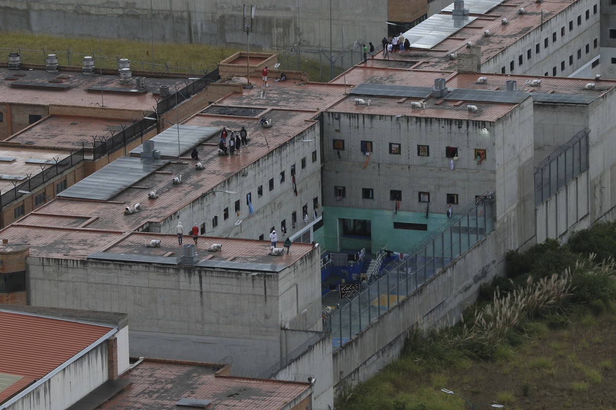 Des prisonniers se tiennent sur le toit d'une prison où des dizaines de gardiens et de policiers ont été kidnappés.