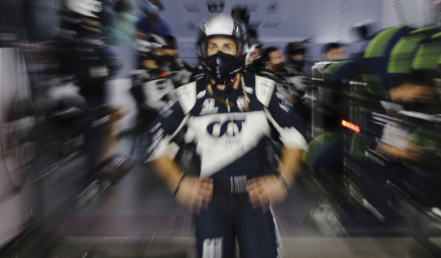 epa09595845 A mechanic of Scuderia AlphaTauri Honda follows the 2021 Formula One Grand Prix of Qatar at the Losail International Circuit in Lusail, Qatar, 21 November 2021. EPA/HAMAD I MOHAMMED / POOL