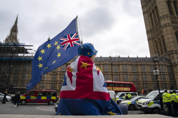 epa07835611 An Anti-Brexit protester sits outside the Houses of Parliament, Central London, Britain, 11 September 2019. Judges at the Court of Session in Scotland ruled today that proroguing of Parlia ...