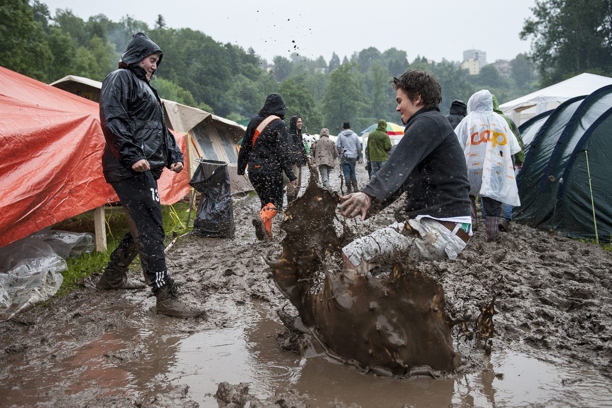 A visitor is jumping in the mud at the OpenAir St. Gallen on Saturday, June 29, 2013, in St. Gallen. The OpenAir St.Gallen is one of the oldest outdoor festivals in Switzerland. It's close to the ...