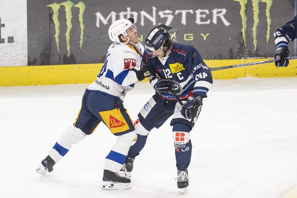 From left, Zug player Anndress Wingerli and Ambri player Daniele Grassi, during the National League match between HC Ambri Piotta and EV Zug at the ice stadium Gottardo Arena in Ambri, Switzerland, Fr ...