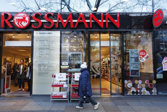 BERLIN, GERMANY - JANUARY 08: Pedestrians pass by a Rossmann drogerie Store on January 8, 2018 in Berlin, Germany. According to government statisticians, nominal revenue grew compared to the previous  ...