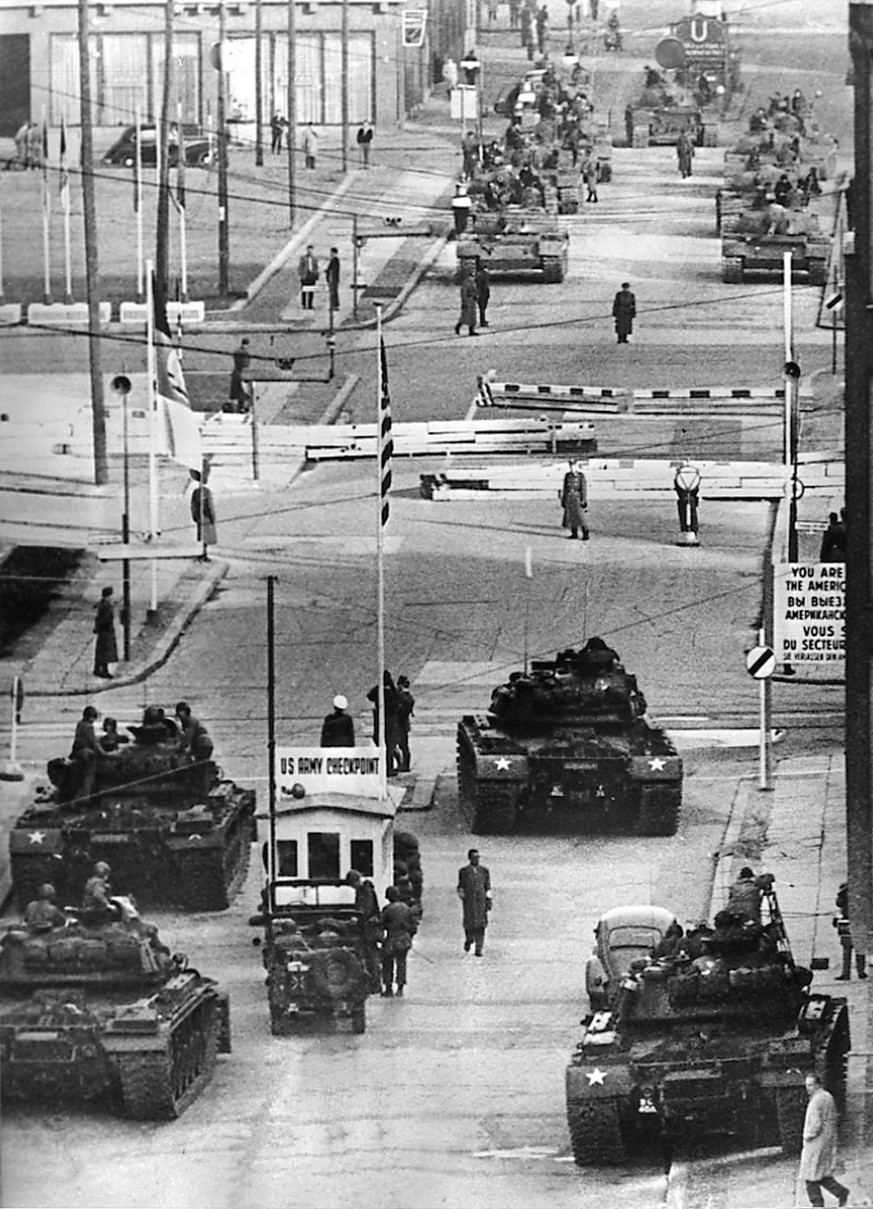 U.S. Army tanks, foreground, face off against Soviet tanks across the Berlin Wall at Checkpoint Charlie on the Friedrichstrasse, in a tense standoff on Oct. 27 and 28, 1961. (AP Photo)