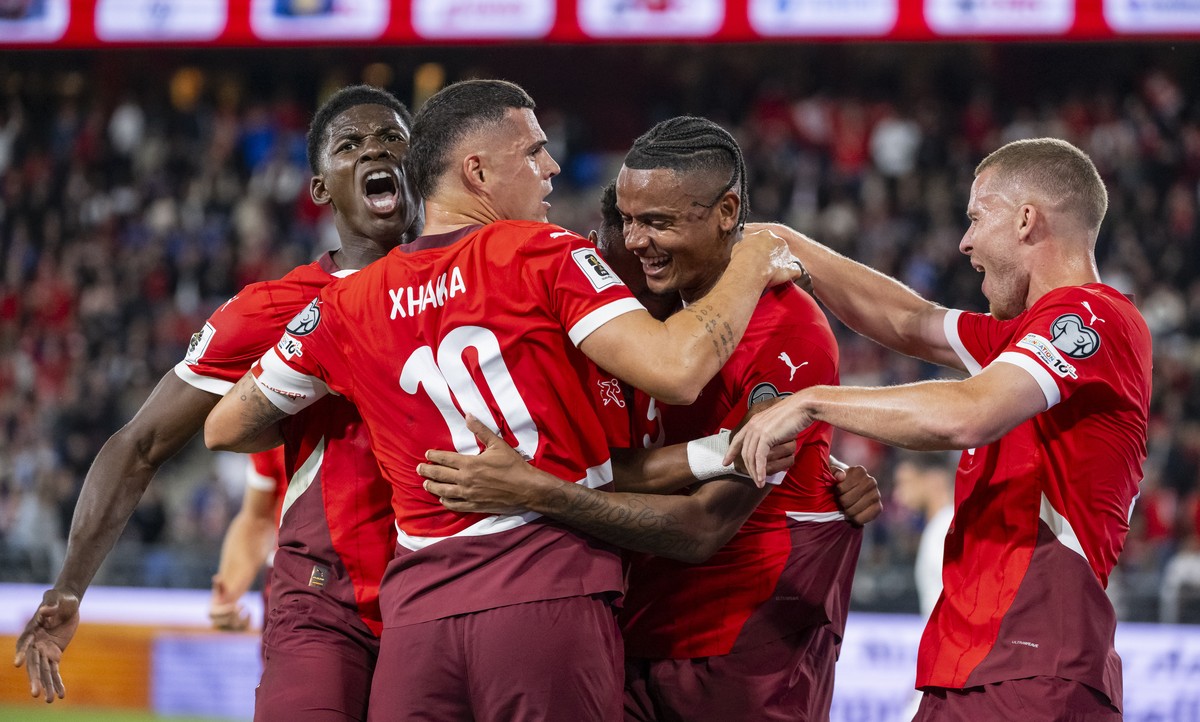 KEYPIX - Switzerland's Manuel Akanji, center, celebrates after scoring to 1:0 with teammates from left, Breel Embolo and Granit Xhaka, and Silvan Widmer, right, during the FIFA 2026 World Cup Gro ...