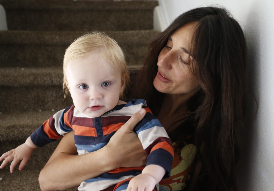 In this Thursday, Oct. 20, 2016 photo, vegan mother Fulvia Serra holds her 1-year-old son, Sebastiano, at home in Fort Collins, Colo. Serra, originally from Italy, and her husband, Scott, are raising ...