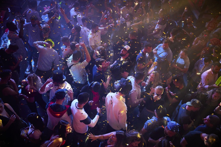 Club goers party at the MAD (Moulin a Danse) night club on the first evening after COVID-19 measures were eased enabling the reopening of discotheques at full capacity and without mask upon presentati ...