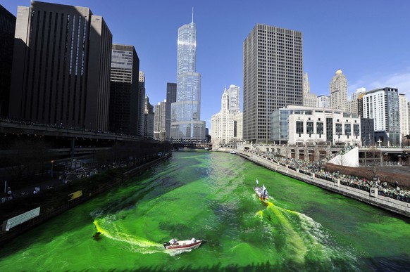 CHICAGO, IL - MARCH 17: Members of the plumbers' union dye the Chicago River green for St. Patrick's Day on March 17, 2012 in Chicago, Illinois. The River was first dyed green in 1962 and ha ...