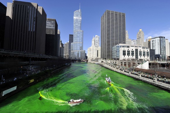 CHICAGO, IL - MARCH 17: Members of the plumbers&#039; union dye the Chicago River green for St. Patrick&#039;s Day on March 17, 2012 in Chicago, Illinois. The River was first dyed green in 1962 and ha ...