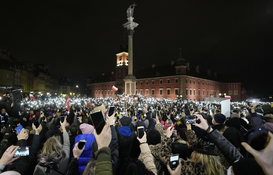 People light up their mobile phone torches in Warsaw, Poland, on Saturday, Nov. 6, 2021, to protest restrictive abortion law that critics say led to a recent death of a woman with troubled pregnancy.  ...