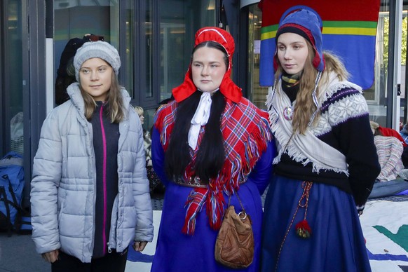 Environmental activist Greta Thunberg, left, joins activists Elle Nystad, center, and Ella Marie H