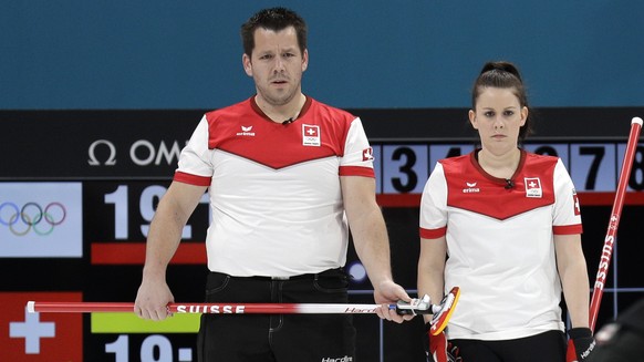 Switzerland Martin Rios, left, and Jenny Perret, second from left, watch Russian athletes during their mixed doubles curling semi-final match at the 2018 Winter Olympics in Gangneung, South Korea, Mon ...