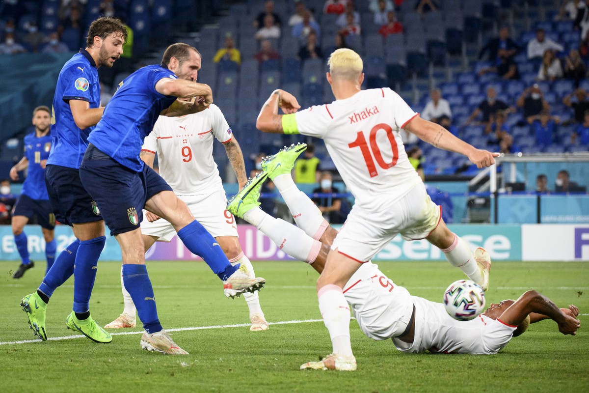 Italy's defender Giorgio Chiellini, second from left, scores a goal cancelled for a hand foul, in front of Italy's midfielder Manuel Locatelli, left, Switzerland's midfielder Granit Xha ...