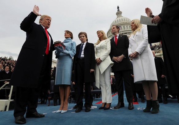 U.S. President Donald Trump takes the oath of office as his wife Melania holds the bible and his children Barron, Ivanka, Eric and Tiffany watch as U.S. Supreme Court Chief Justice John Roberts (R) ad ...