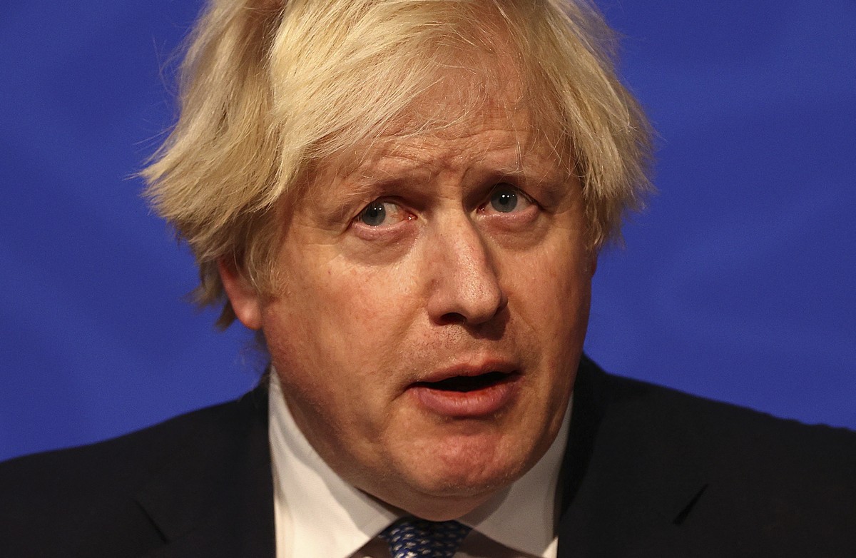 Britain's Prime Minister Boris Johnson, center, Chief Medical Officer for England Chris Whitty, left, and Chief Scientific Adviser Patrick Vallance attend a press conference in London's Down ...