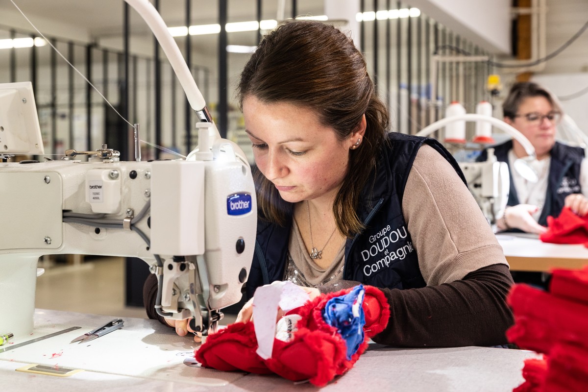 epa10402595 A woman sews fabric to create the Phryges, the mascot of the Olympic Games Paris 2024 in the factory of the group Doudou et Compagnie in La Guerche de Bretagne, France, 11 January 2023 (is ...