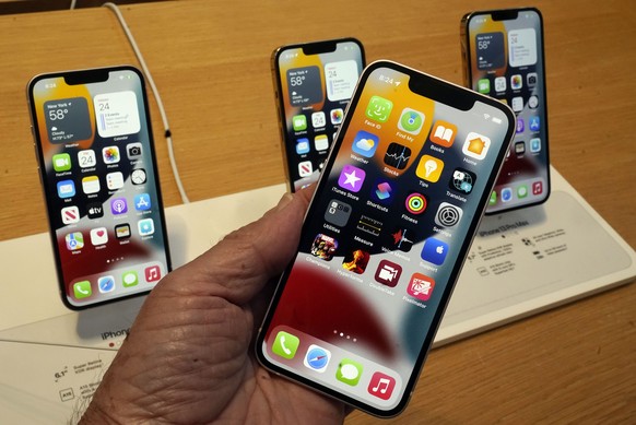 FILE - The line-up of the Apple iPhone 13 is displayed on their first day of sale, in New York, Friday, Sept. 24, 2021, iPhone 13 mini, foregroud, iPhone 13, iPhone 13 Pro, and iPhone 13 ProMax, left  ...