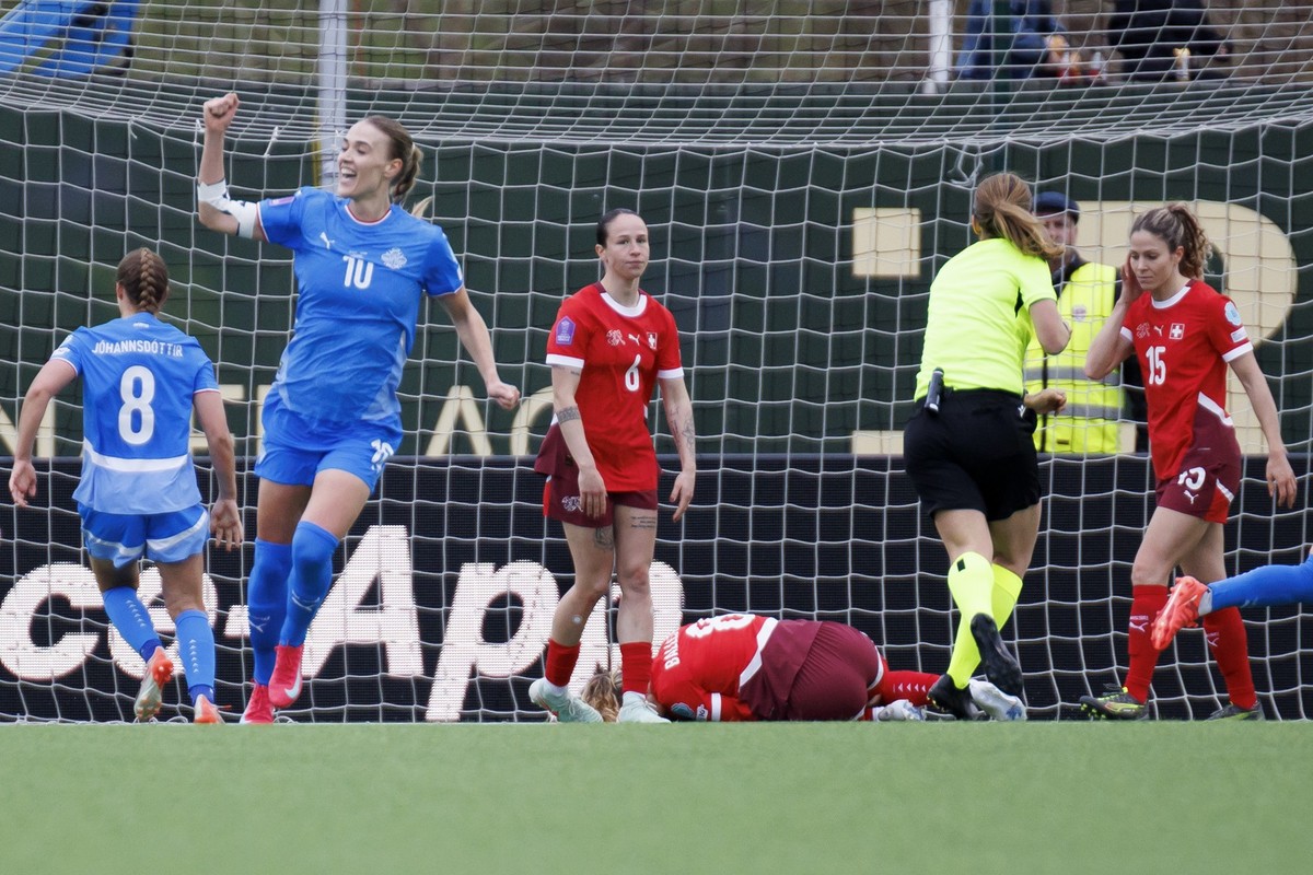 In red from left, Switzerland's Geraldine Reuteler, Switzerland's Laia Balleste and Switzerland's Luana Buehler react next to Iceland's Dagny Brynjarsdottir, left, during the UEFA  ...