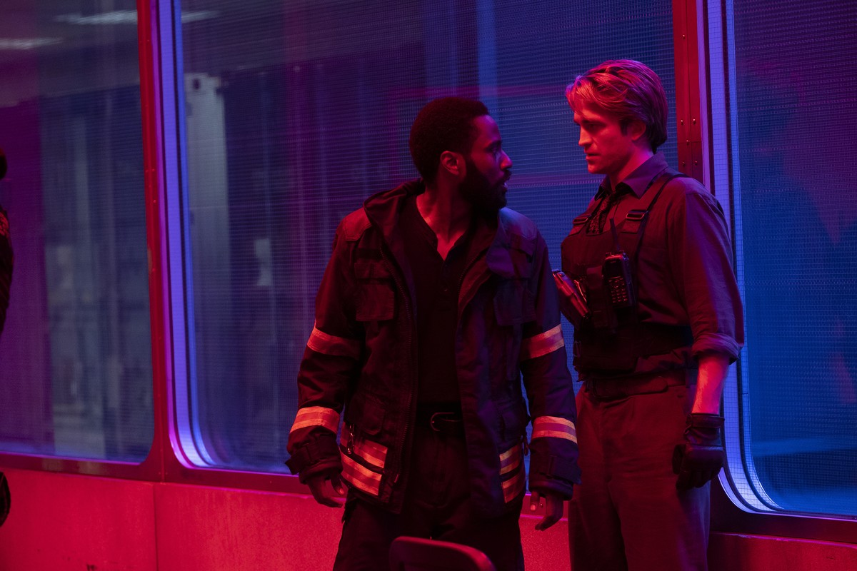 This image released by Warner Bros. Entertainment shows Robert Pattinson, right, and John David Washington in a scene from "Tenet." Warner Bros. says it is delaying the release of Christophe ...