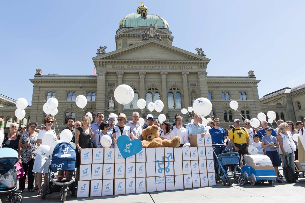 Aktionsteilnehmer posieren mit Schachteln vor dem Bundeshaus, bei der Einreichung der Unterschriften fuer die Volksinitiative "Fuer einen vernuenftigen Vaterschaftsurlaub", am Dienstag, 4. J ...