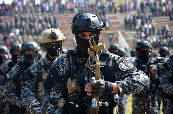 epa10537570 Members of the Syrian Democratic Forces (SDF) attend the funeral procession of their comrades killed in a helicopter that crashed in northern Iraq, in the town of Qamishli, northeast of Sy...