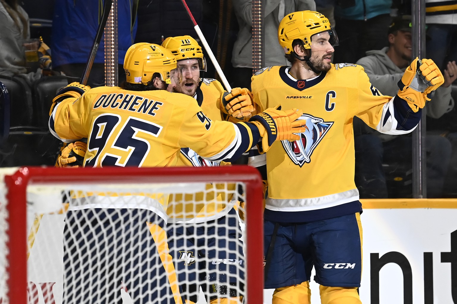 Nashville Predators center Colton Sissons (10) celebrates with Matt Duchene (95) and Roman Josi (59) after Sissons scored a goal against the Anaheim Ducks during the second period of an NHL hockey gam ...