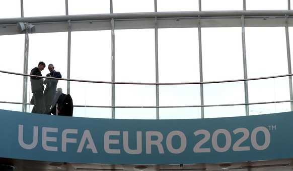 People look from a balcony with UEFA Euro 2020 soccer championship branding at the Convention Centre, Dublin, Sunday December 2, 2018, ahead of the UEFA Euro 2020 qualifying draw, at the Convention Ce ...