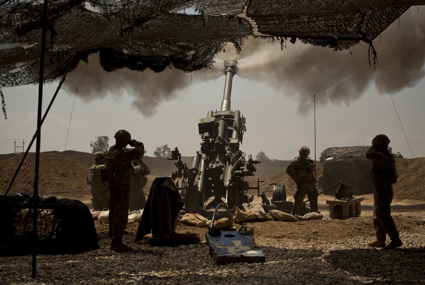 U.S. soldiers from the 82nd Airborne Division fire artillery in support of Iraqi forces fighting Islamic State militants from their base east of Mosul on Monday, April 17, 2017. The soldiers are from  ...