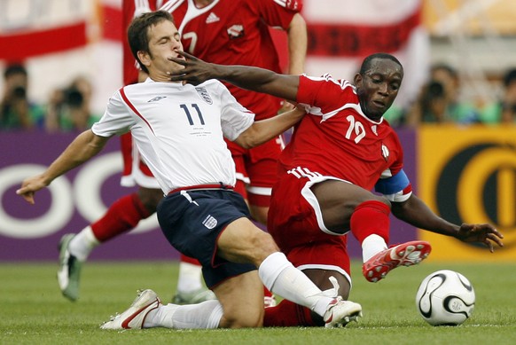 FILE - England&#039;s Joe Cole, left and Trinidad &amp; Tobago&#039;s Dwight Yorke fight for the ball during the first half of their World Cup Group B soccer match in Nuremberg, Germany, June 15, 2006 ...