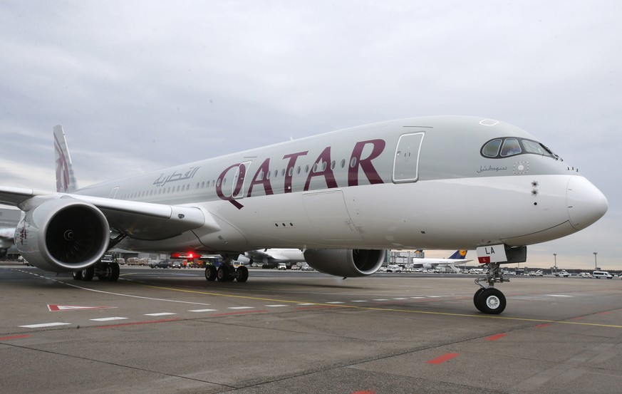 FILE - In this Jan. 15, 2015, file photo, a new Qatar Airways Airbus A350 approaches the gate at the airport in Frankfurt, Germany. Qatar Airways is buying nearly 10 percent of Hong Kong carrier Catha ...