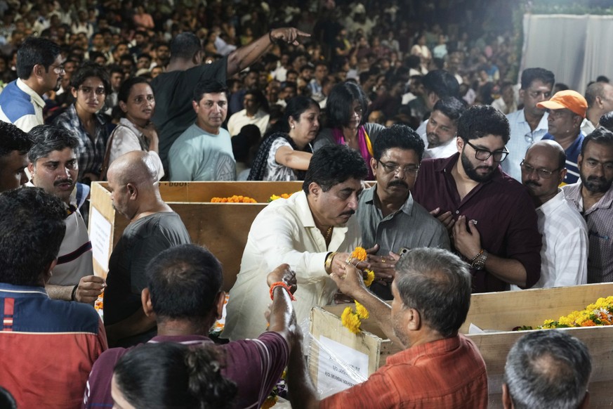 Mourners pay last respect to Hemant Joshi, Sanjay Lele and Atul Mone, who were victims in a deadly attack on tourists in the Pahalgam region of Indian-administered Kashmir, at Dombivali near Mumbai, I ...
