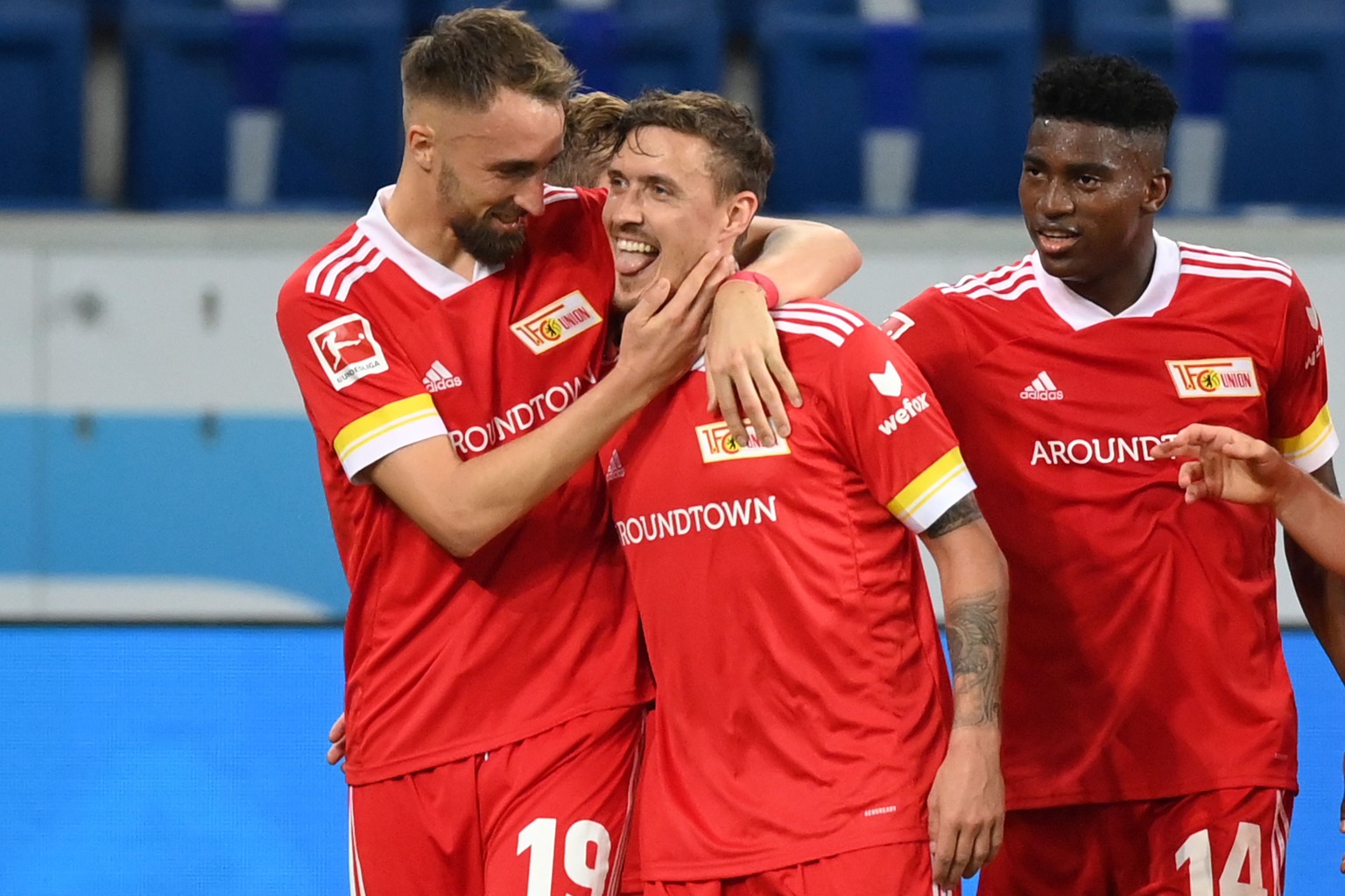 epa08794151 Max Kruse (C) of Union Berlin celebrates scoring a goal with his team mate Florian Huebner (L) during the German Bundesliga match between TSG Hoffenheim and 1. FC Union Berlin at PreZero-A ...