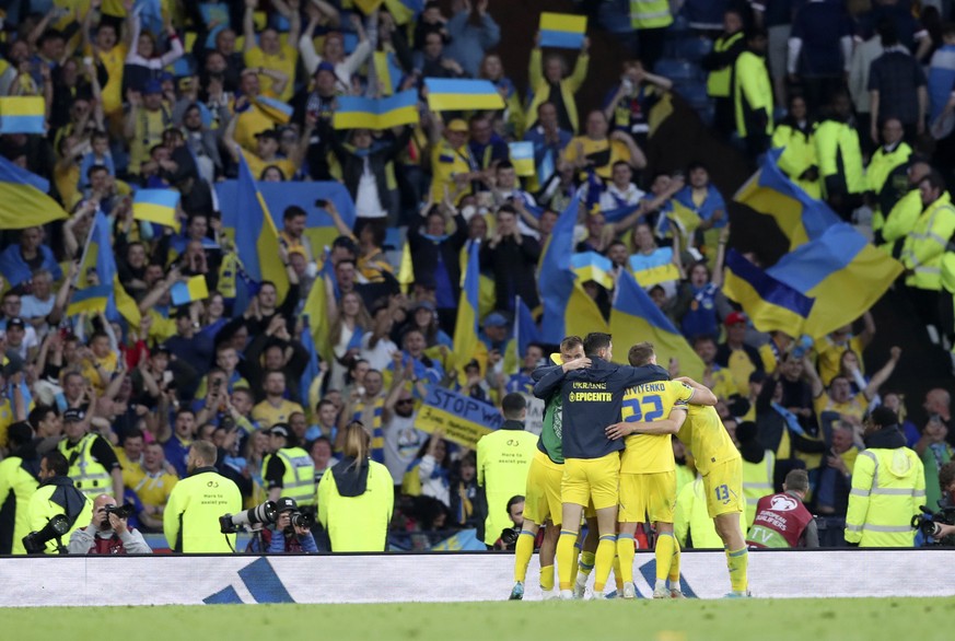 Ukrainian players celebrate at the end of the World Cup 2022 qualifying play-off soccer match between Scotland and Ukraine at Hampden Park stadium in Glasgow, Scotland, Wednesday, June 1, 2022. (AP Ph ...