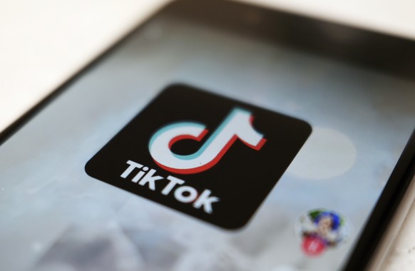FILE - This Monday, Sept. 28, 2020, file photo, shows the TikTok logo on a smartphone in Tokyo. The Chinese government has made investments in two of the nation&#039;s most significant technology firm ...