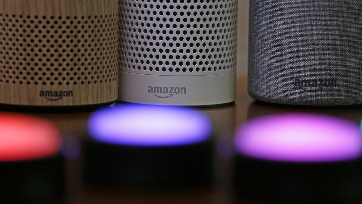 FILE - In this Sept. 27, 2017, file photo, Amazon Echo and Echo Plus devices, behind, sit near illuminated Echo Button devices during an event announcing several new Amazon products by the company in  ...