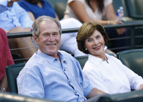 ARLINGTON, TX - SEPTEMBER 19: Former U.S. president George W. Bush and former First Lady Laura Busy wait for the start of the game between the Seattle Mariners and the Texas Rangers at Globe Life Park ...