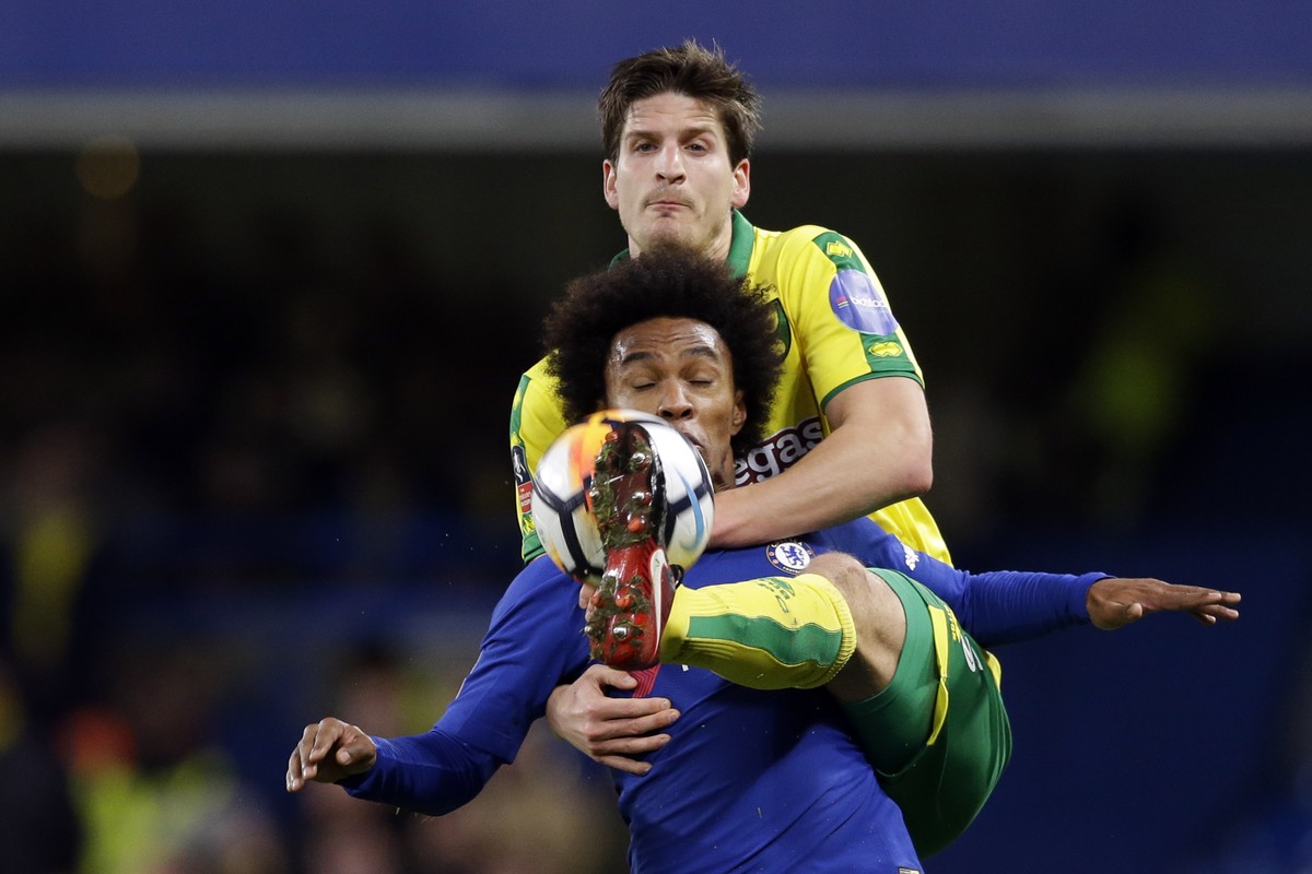 Chelsea's Willian, front, duels for the ball with Norwich City's Timm Klose during the English FA Cup third round replay between Chelsea and Norwich City at the Stamford Bridge, in London, W ...
