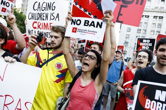 epa06850833 People gather for a march and rally against the Immigration and Customs Enforcement (ICE) division of the Department of Homeland Security and the Trump Administration&#039;s immigration po ...