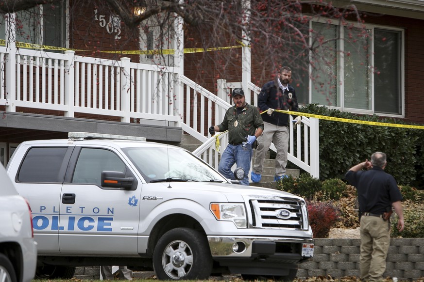 Members of the Mapleton Police Department and forensics gather evidence outside a home in Mapleton, Utah on Friday, Nov. 10, 2017. A Utah family of four and their dog have been found dead with gunshot ...