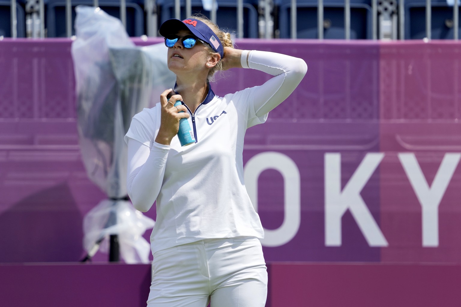 Nelly Korda, of the United States, applies sunscreen during a practice round prior to the women&#039;s golf event at the 2020 Summer Olympics, Monday, Aug. 2, 2021, at the Kasumigaseki Country Club in ...