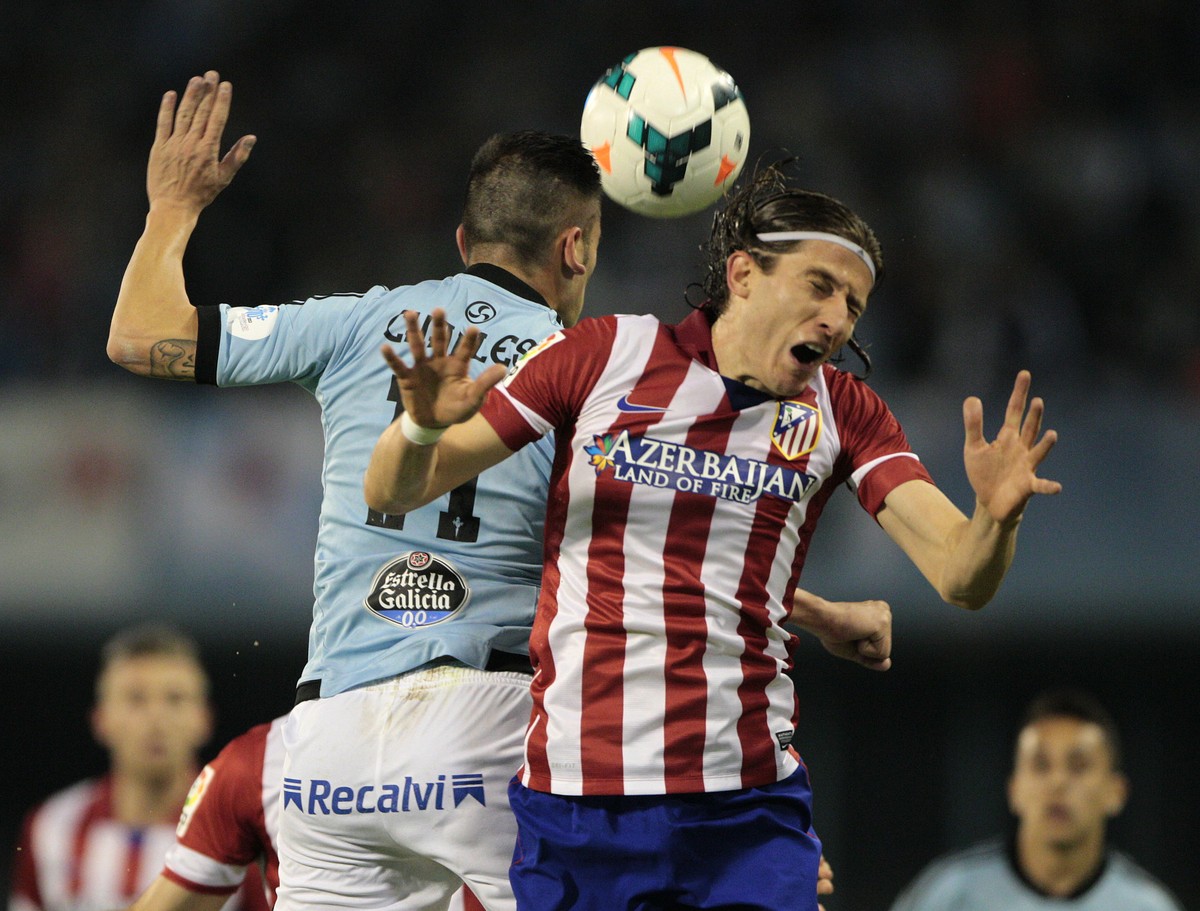 Atletico's Filipe Luis from Brasil, right vies for the ball with Celta's Charles from Brasil during a Spanish La Liga soccer match at the Balaidos stadium in Vigo, Spain, Saturday, March 8,  ...