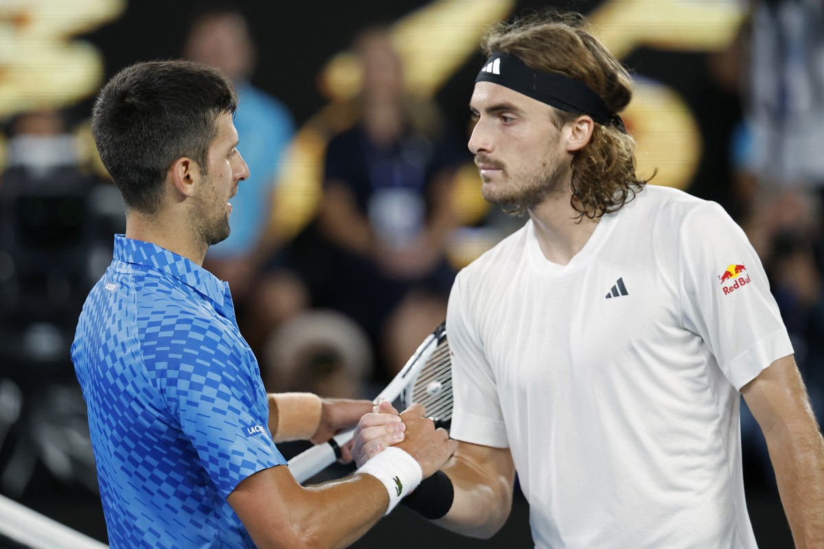 Novak Djokovic of Serbia, left, shakes hands with Stefanos Tsitsipas of Greece after Djokovic won the men's singles final at the Australian Open tennis championships in Melbourne, Australia, Sund ...
