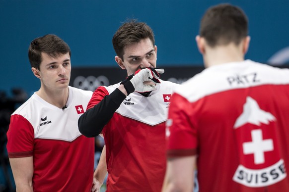 Benoit Schwarz, Peter de Cruz and Claudio Paetz of Switzerland, from left, in action during the Curling round robin game of the men between Switzerland and Great Britain at the XXIII Winter Olympics 2 ...